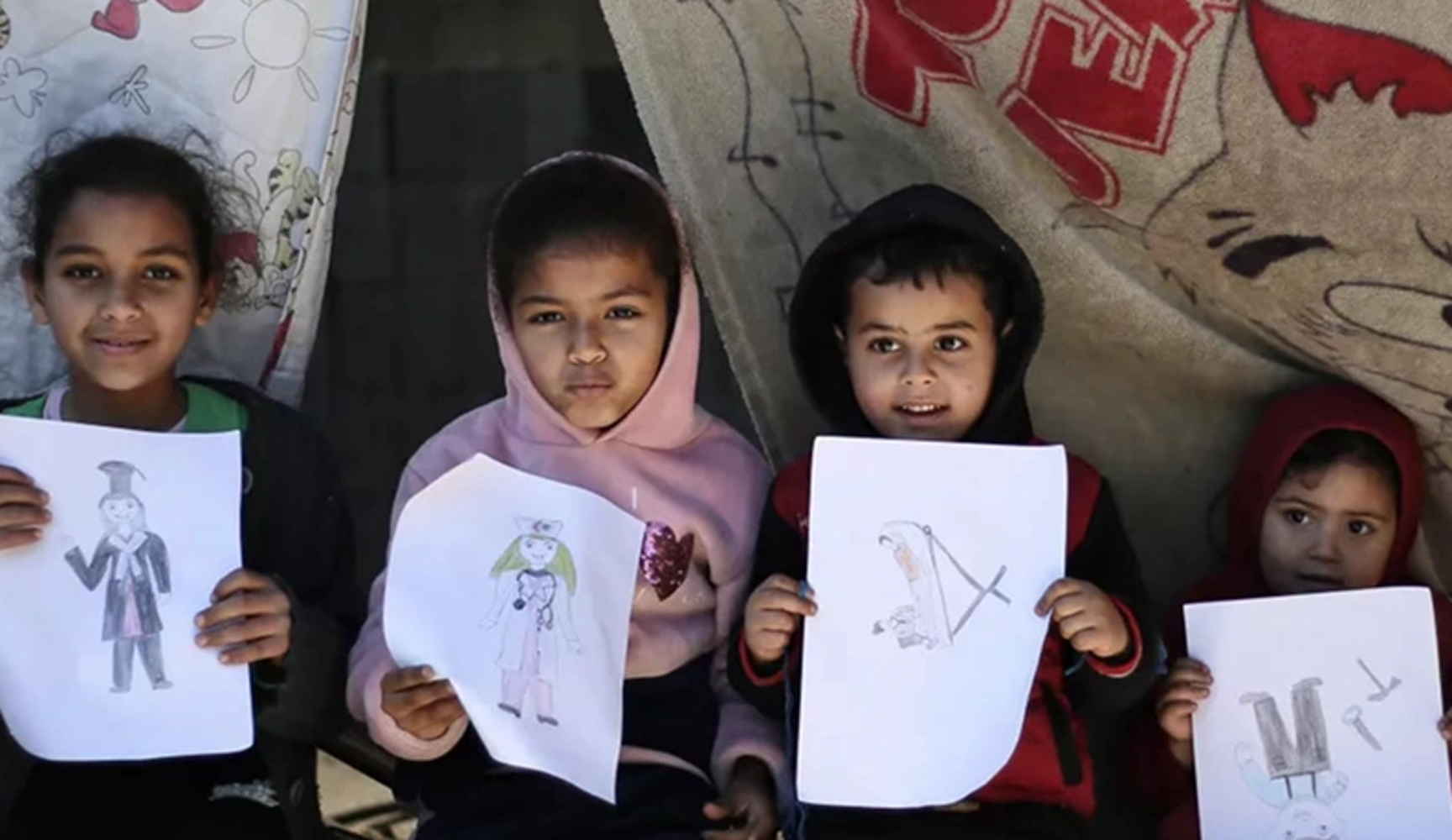 children holding their drawings